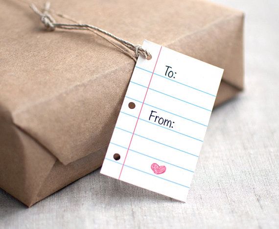 a gift wrapped in brown paper with a note attached to it