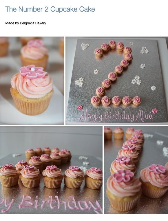 the birthday cake is decorated with pink frosting and icing, along with cupcakes