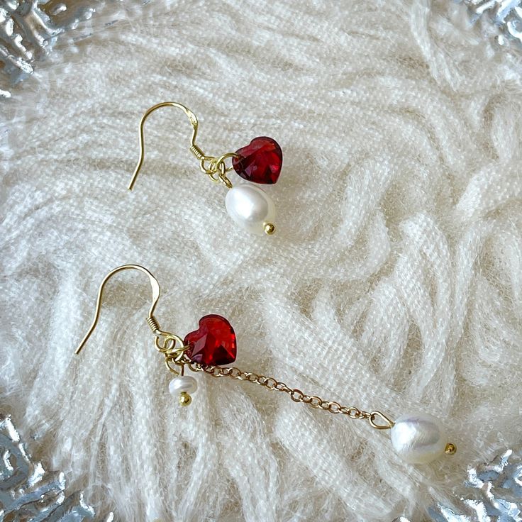 Dainty red ruby heart earrings in 14K gold plated sterling silver, with mismatched freshwater pearl dangles. Stunning sweetheart style red heart gemstone charm, super cute and delicate, asymmetrical drop dangle pearls gives you elegant modern romance accent♥ Minimalist dainty earrings, looks luxurious and gorgeous. Be the sweetest angel easily! All of jewelry are designed and handmade in NYC, with exquisite delicate details. 💎 Features: ♥ Material: 14K gold plated sterling silver, with "925s" s Red And Pearl Earrings, Diy Earrings Pearl, Red Ruby Earrings, Earring Inspo, Red Heart Earrings, Emerald Green Earrings, Ruby Heart, Red Pearl, Fun Clothes