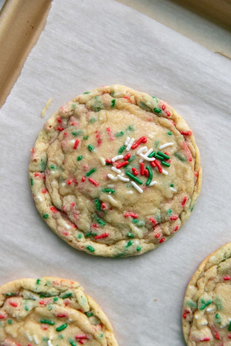 three cookies with sprinkles and white frosting