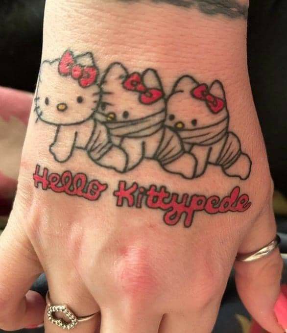 a person with a hello kitty tattoo on their hand