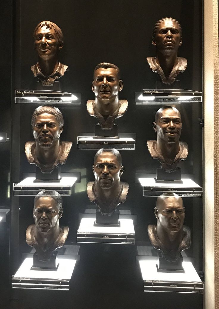 a display case filled with busturines of men's heads