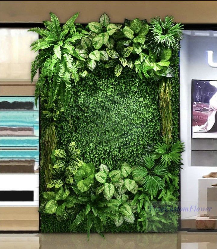 a green wall in an office with plants growing on it