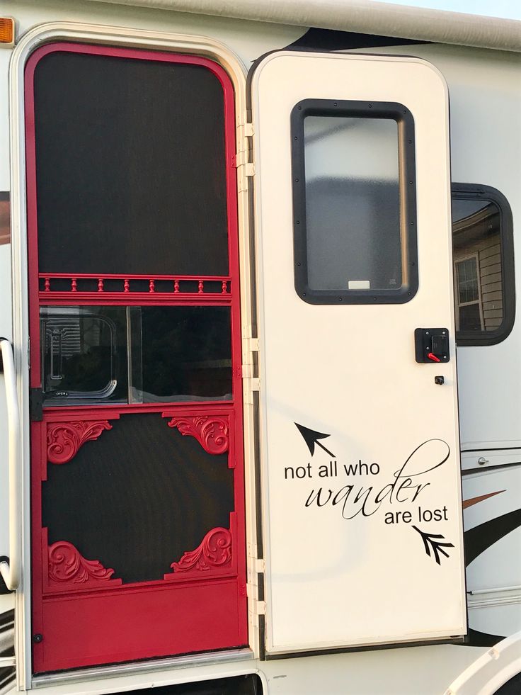 an rv with the door open and not all who wander are lost written on it