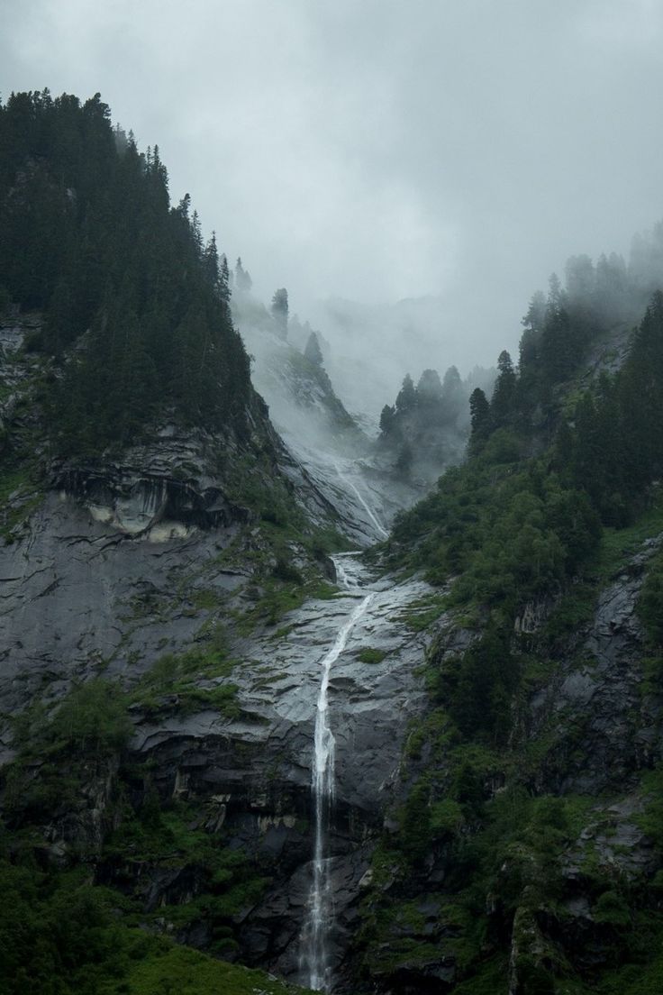 a waterfall is coming down the side of a mountain