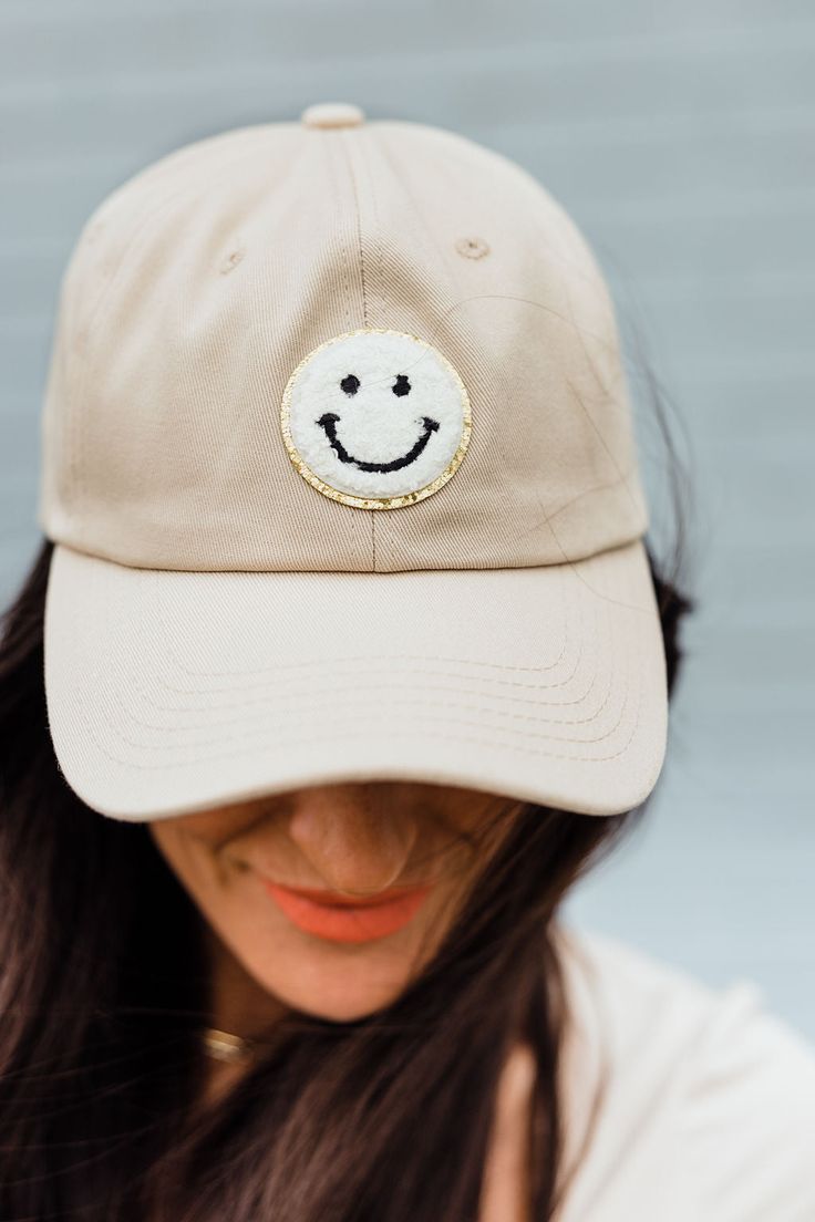 THIS SALE ITEM IS FINAL SALE! Unlock your sunny style this season with Happy Dayz Hat-Tan! Featuring a baseball cap with a cheerful smiley patch embellished with a glimmering gold outline, you'll be beaming with joy wherever you go! Show the world your perkiness in one simple step - we guarantee you'll make everyone smile! Happy Dayz Hat-Tan, boutique clothing, casual, the perfect hat! Boutique Clothing Playful Trucker Hat With Graphic, Trendy Smiley Face Baseball Cap, Smiley Trucker Hat, Smiley Face Trucker Hat, Fun Smiley Face Trucker Hat, Hat Boutique, Clothing Casual, Boutique Clothing, Smiley