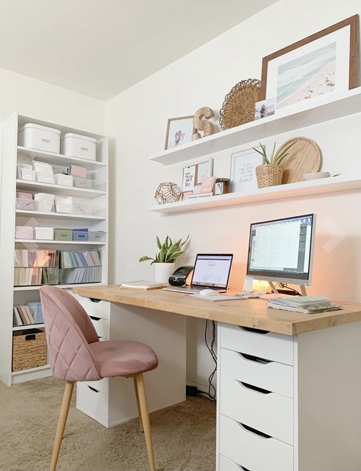 a desk with a laptop and a desktop computer on it in front of a bookshelf