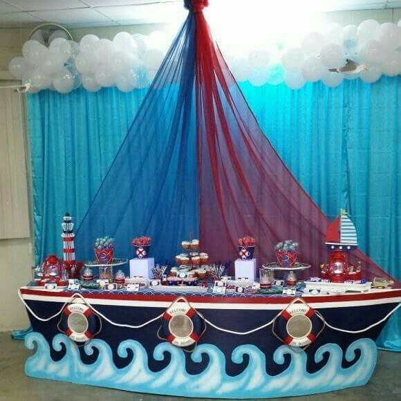 a decorated boat is in the middle of a room with blue drapes and curtains