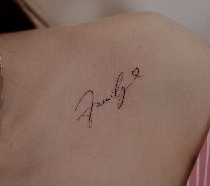 a woman's back with the word family written in cursive writing on it