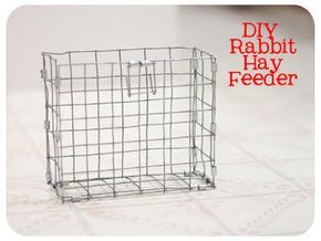 a small metal cage sitting on top of a tiled floor next to a red and white sign