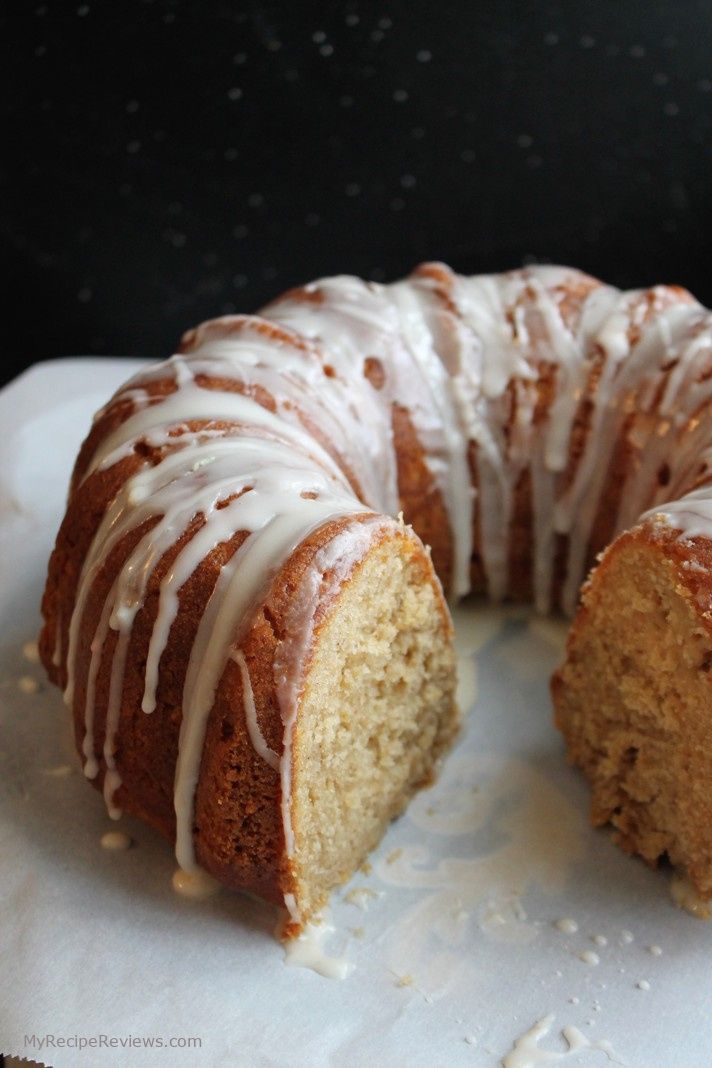 a bundt cake with white icing sitting on top of a table