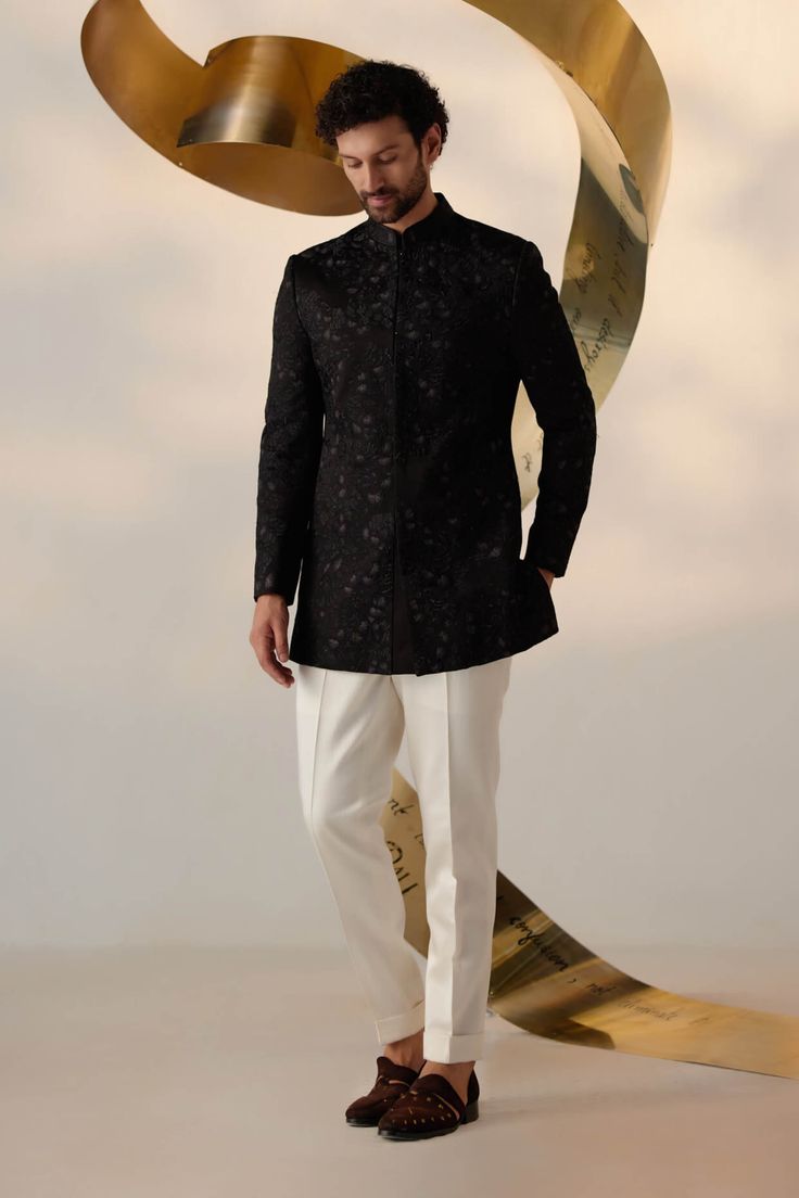 Editor's Note Showcasing our new long bandhgala silhouette in black color. Hand embroidered with tone-on-tone, bluish-gray, and gold threads in an abstract manner all-over. Paired with ivory tapered trousers. Fabric: Linen silk Color: Black, ivory Components: Bandhgala and trousers Occasion: Wedding guest Fit: Regular Note: Product colour may slightly vary due to photographic lighting sources Care: Dry clean only About the Designer After establishing himself as the leading couturier in the indus Blouse Yoke, Personal Shopping Service, Mens Kurta Designs, Bluish Gray, Indian Man, Haldi Ceremony, Royal Look, Tapered Trousers, Indian Wedding Outfits