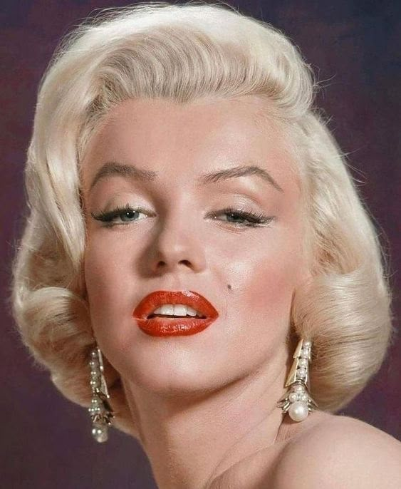 marilyn monroe is wearing red lipstick and gold earring earrings in the 1950's