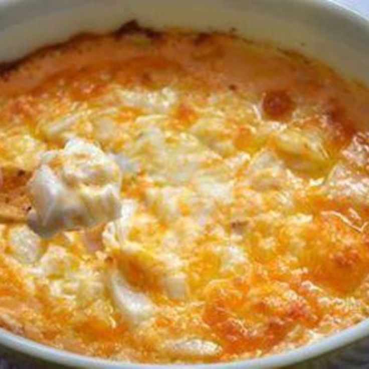 a close up of a bowl of food with cheese