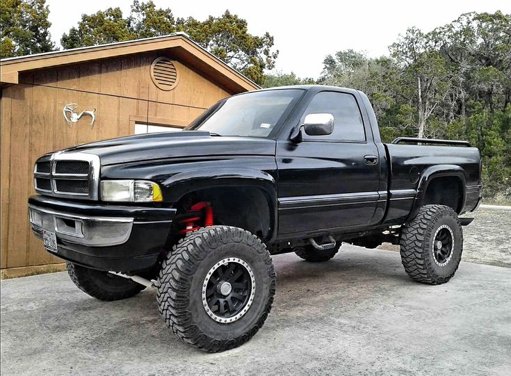 a black truck parked in front of a building