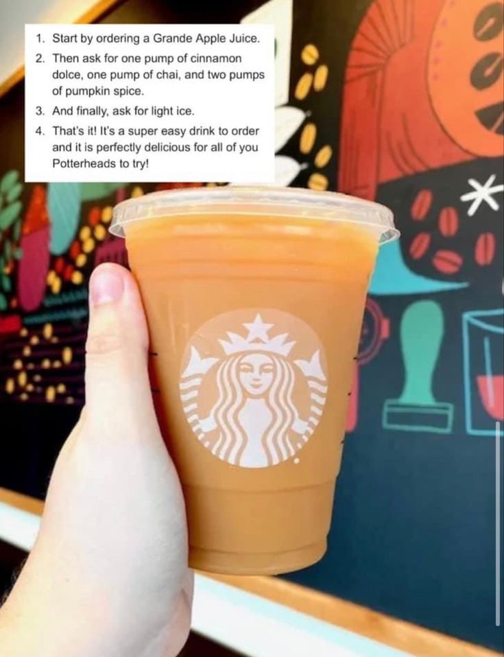 someone holding up a starbucks cup with information about it