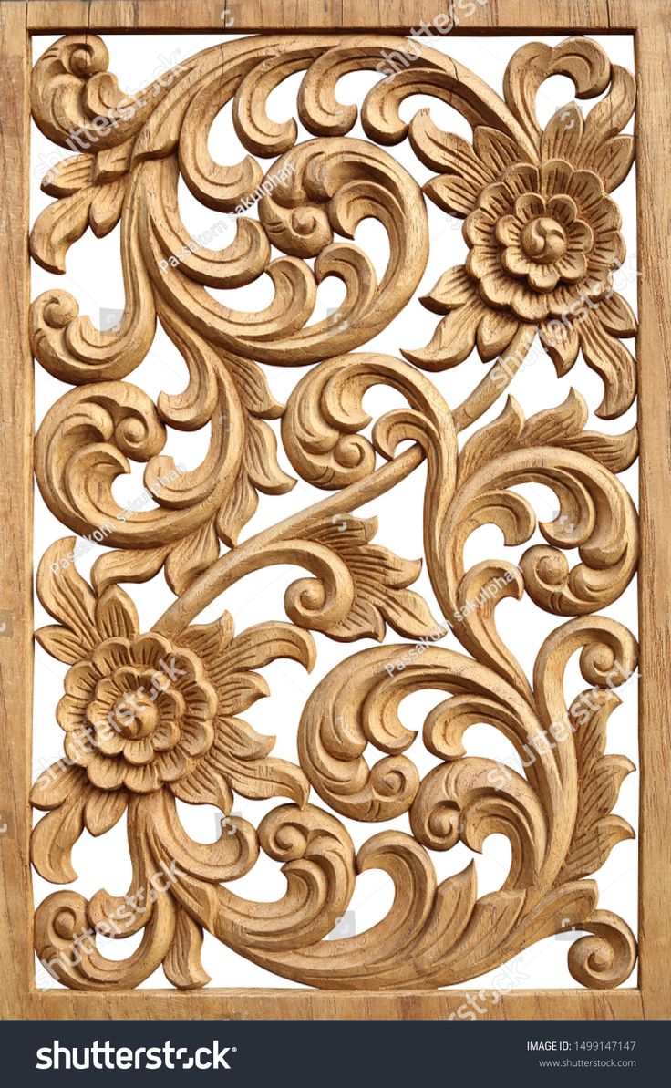 an intricate carved wood panel with flowers and leaves