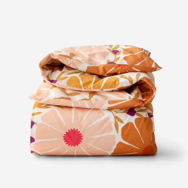 three sheets stacked on top of each other with orange and pink flower designs in them