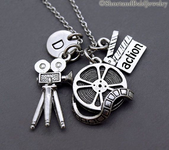 a necklace with some movies on it and the words shorthanded jewelry below it