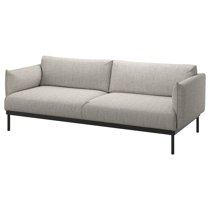 a gray couch sitting on top of a white floor next to a black metal frame