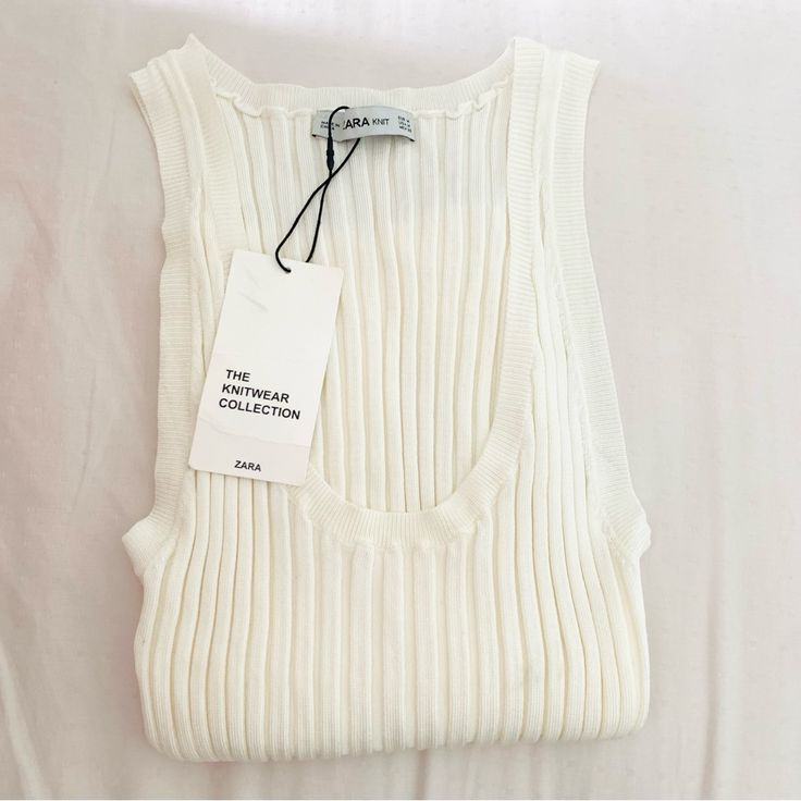 New With Tags Zara Sleeveless White Ribbed Knit Tank - White Ecru - Round Neck - Ribbed Material - Stretchy, Fitted Style Size M. Stretchy. 84% Viscose, 16% Nylon. Would Definitely Fit Someone Who Normally Wears A Small Too. Nwt - Never Worn! Zara The Knitwear Collection. Chic White Ribbed Knit Top, Chic White Tank Top With Ribbed Neckline, White Textured Knit Sleeveless Sweater Vest, White Pointelle Knit Stretch Tank Top, White Stretch Tank Top With Pointelle Knit, White Stretch Pointelle Knit Tank Top, White Ribbed Knit Tank Top, White Sleeveless Tank Top With Ribbed Neckline, Chic White Ribbed Tank Top