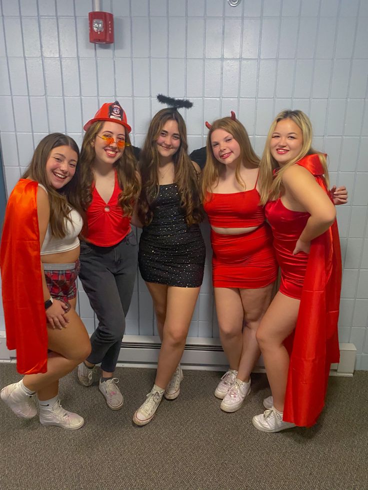 four girls dressed up in costumes posing for the camera