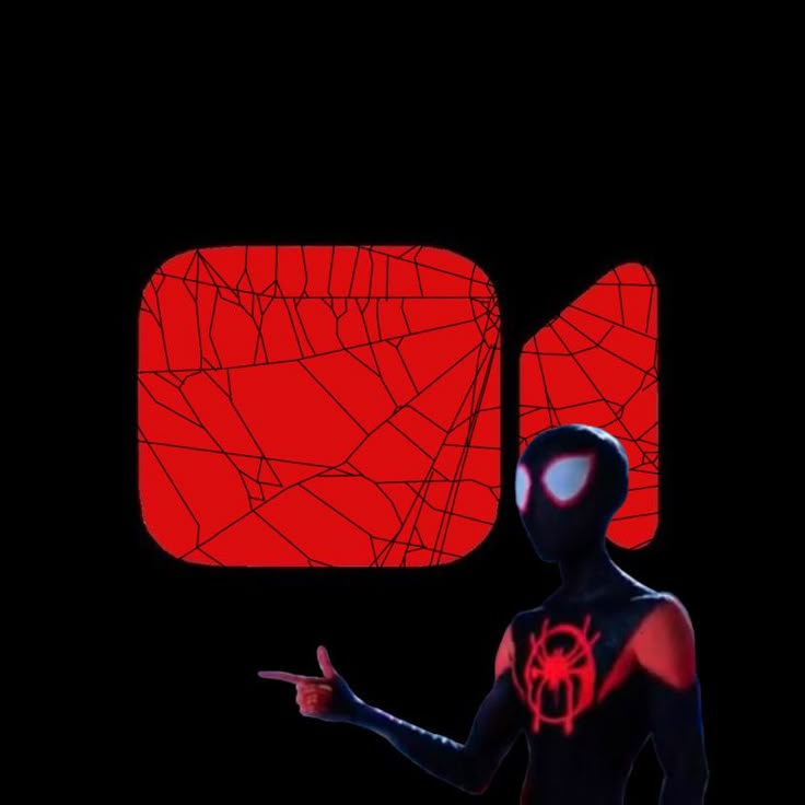 a man in black and red is holding his hand out to the side while wearing a spiderman mask