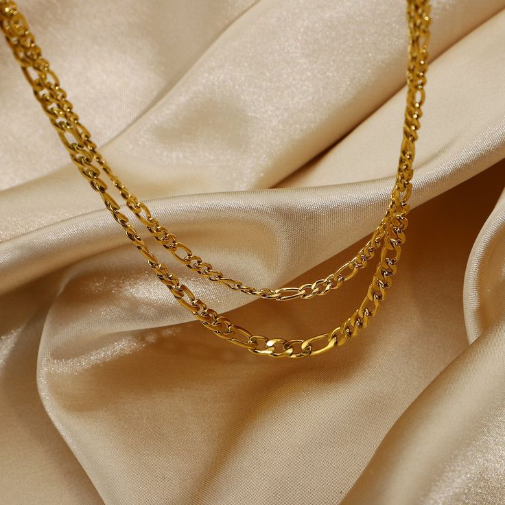 This Layered Gold Figaro Necklace, with its 18k gold-plated layers, brings a sophisticated flair. Its classic Figaro chain design offers timeless elegance, perfect for enhancing both everyday and formal ensembles. Chunky Gold Necklaces, Figaro Necklace, Figaro Chain Necklace, Layered Chokers, Stacked Necklaces, Layered Necklace Set, Daily Jewelry, Senior Prom, Dainty Gold Necklace