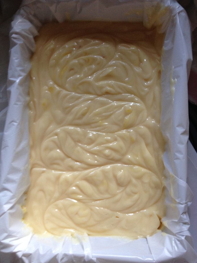 a cake in a pan with white icing on it's edges and swirls