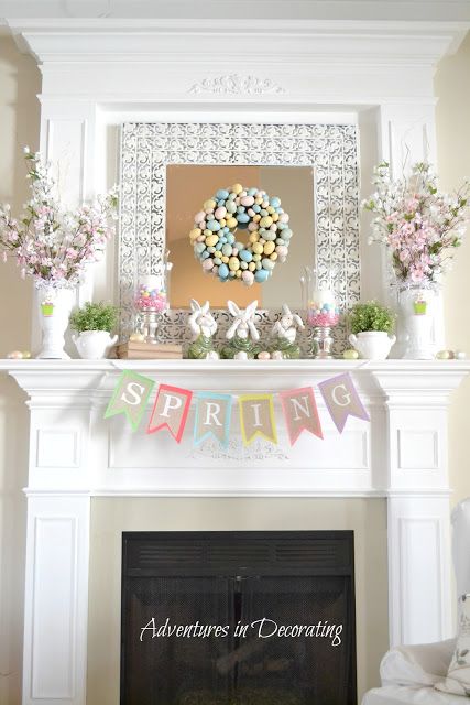 a living room filled with furniture and a fire place covered in flowers on top of a mantle