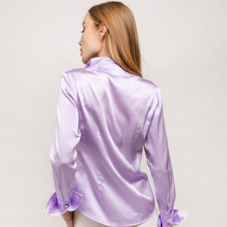 Great quality shirts are always in style! You will love this special bland color Lavender!   This signature silk blouse is decorated with handmade twisted buttons and a soft collar. The light weight and added stretch allows for an effortless drape. The perfect blouse to complete any look of luxury and sophistication. Dress it up for cocktail parties with your favorite skirt or pair with your favorite slacks. It's impossible not to be in the spotlight in this Farinaz tailored silk shirt.  Our bra Feminine Long Sleeve Satin Tops, Purple Long Sleeve Evening Blouse, Elegant Fitted Purple Blouse, Fitted Satin Top With Buttons, Spring Purple Satin Top, Purple Satin Top For Spring, Spring Satin Blouse With Buttons, Purple Silk Long Sleeve Tops, Chic Purple Silk Top