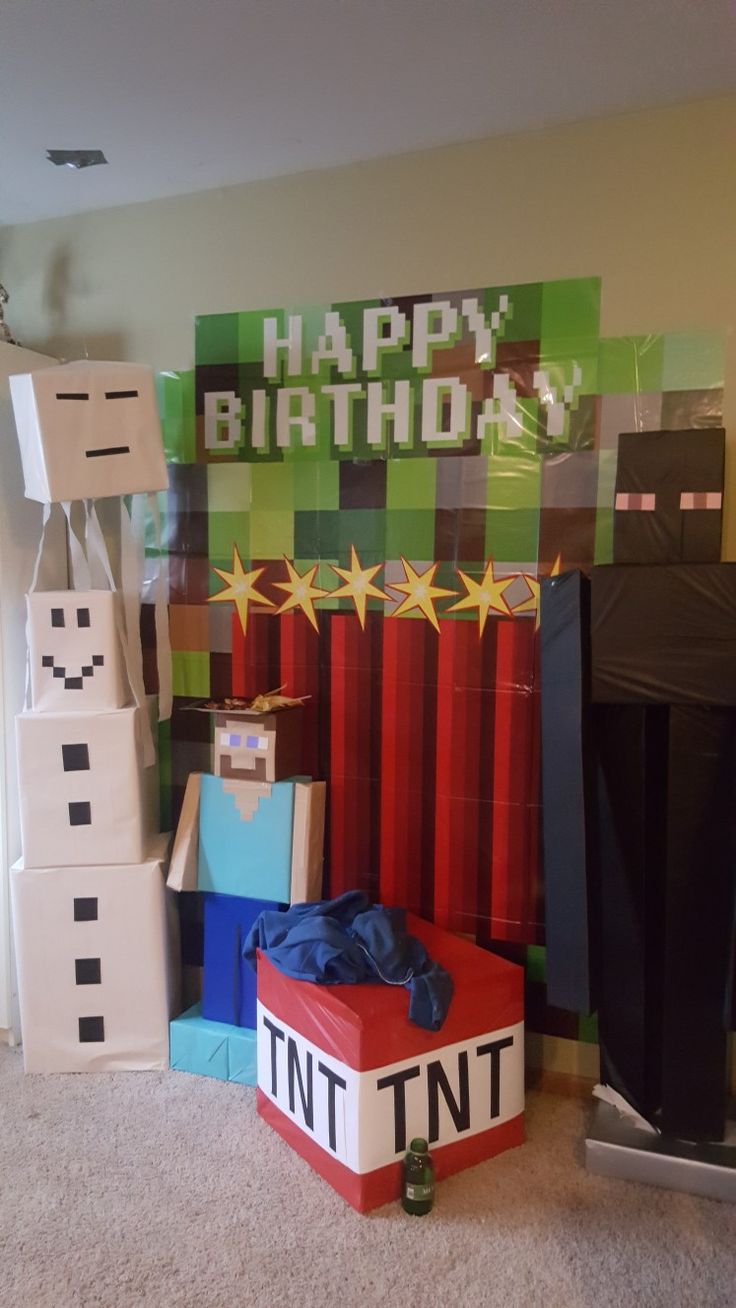 there is a birthday decoration made out of legos and presents on the floor in front of it