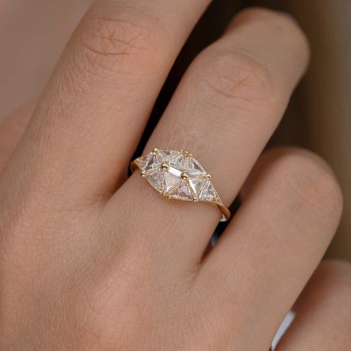 a woman's hand with a diamond ring on it