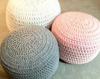 three crocheted poufles sitting on the floor