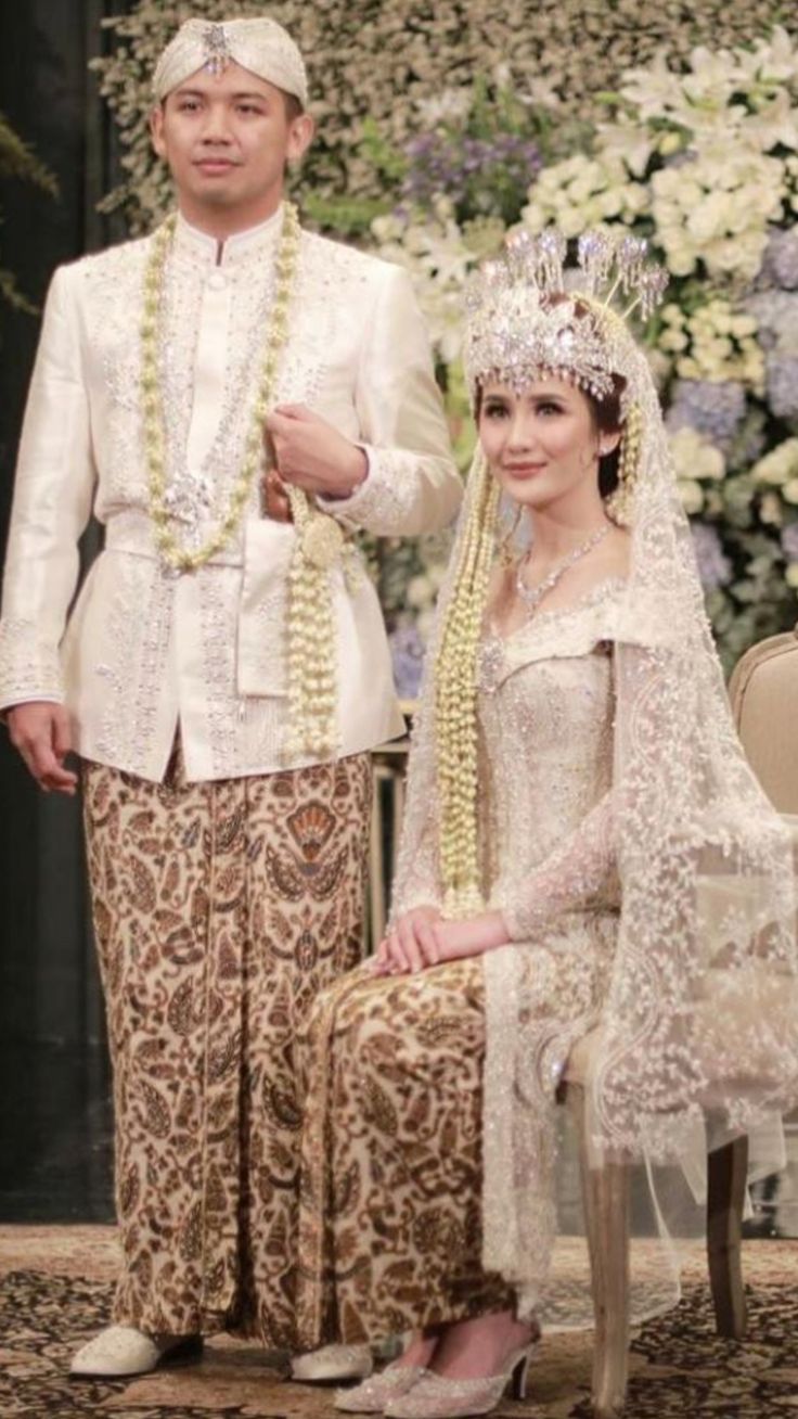 a man and woman dressed in traditional thai garb