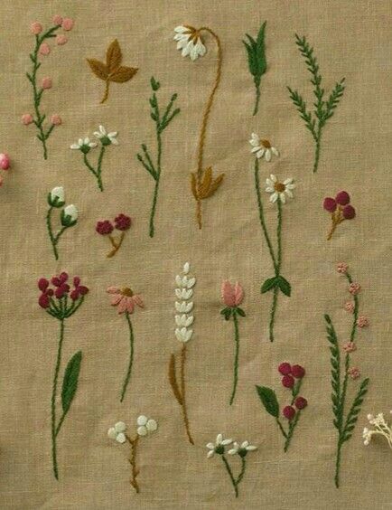 various embroidered flowers and leaves on a piece of cloth