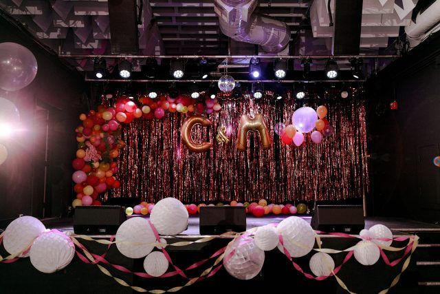 balloons and streamers decorate the stage for an event