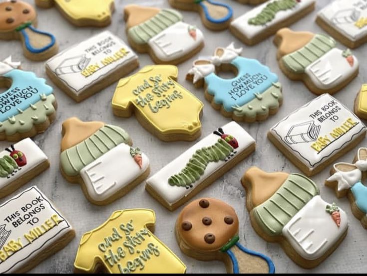 some cookies are decorated with baby items and words that say it's a boy