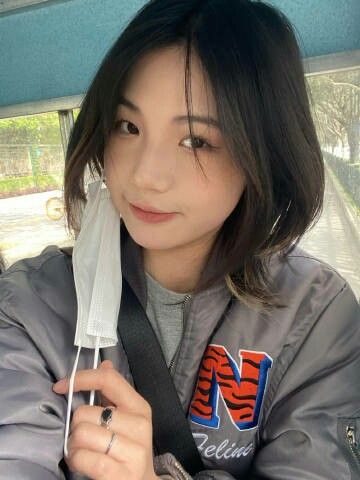 a woman in a car holding an umbrella over her head and looking at the camera