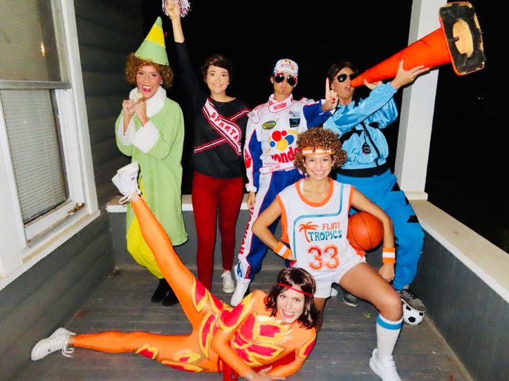 a group of people in costumes posing for a photo