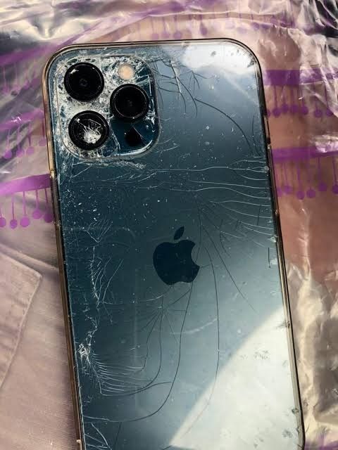 an iphone that has been smashed and is laying on the ground