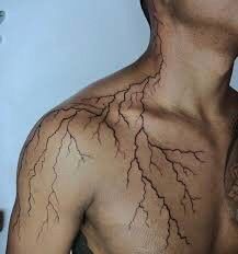 a man with his neck and chest covered in lightning signs on it's back