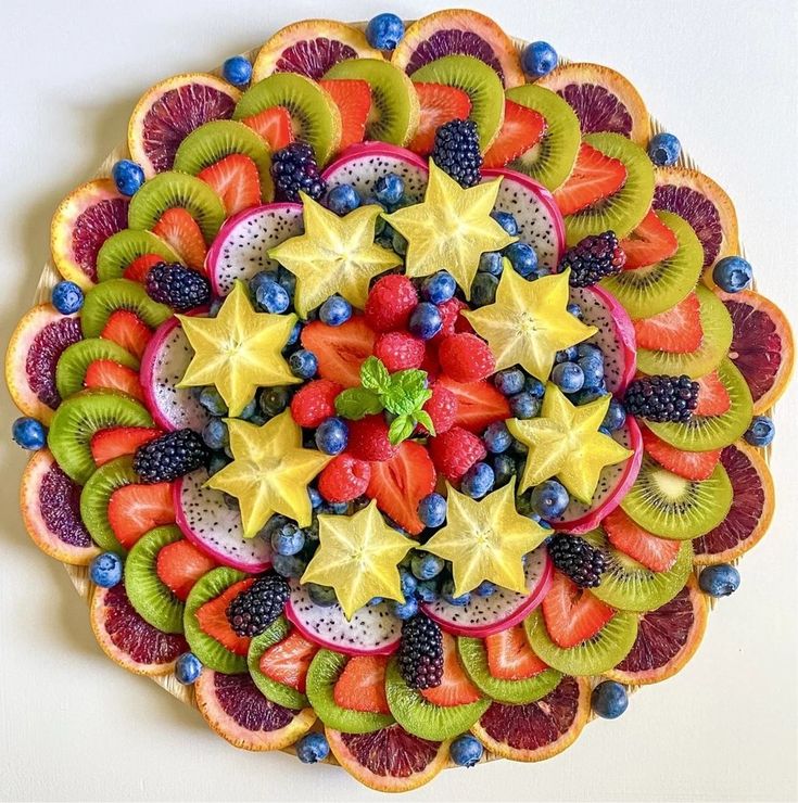 a colorful fruit salad with kiwis, strawberries, oranges and blueberries