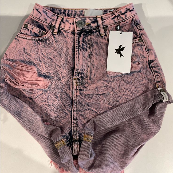 The High Waist Bandits. Our Cult Classic Shorts, But High Waisted! Semi Relaxed In Fit. Fitted Around The Waist And Slouchy Through The Hip. Slouchy In All The Right Places And Includes Our Bower Bird Button And Signature Hem, Rolled And Twisted - Just Like A Bandit. Designed To Fit At The Small Highest Part Of Your Waist. Pink Pistol Is Our New Season Custom Print Wash. A Retro-Styled, Acid-Washed & Overdyed Pink Denim Wash. Trendy Ripped Acid Wash Bottoms, Trendy Acid Wash Bottoms With Frayed Hem, Trendy Distressed Short Bottoms, High Waist Ripped Pink Bottoms, Pink High Waist Ripped Bottoms, Ripped High-waist Jean Shorts For Spring, Trendy Acid Wash Mid-rise Bottoms, Trendy High Waist Washed Bottoms, Trendy High Waist Shorts With Frayed Hem