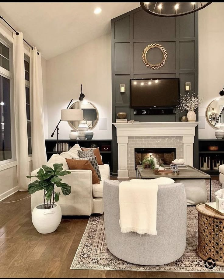 a living room filled with furniture and a flat screen tv mounted on the wall above a fire place