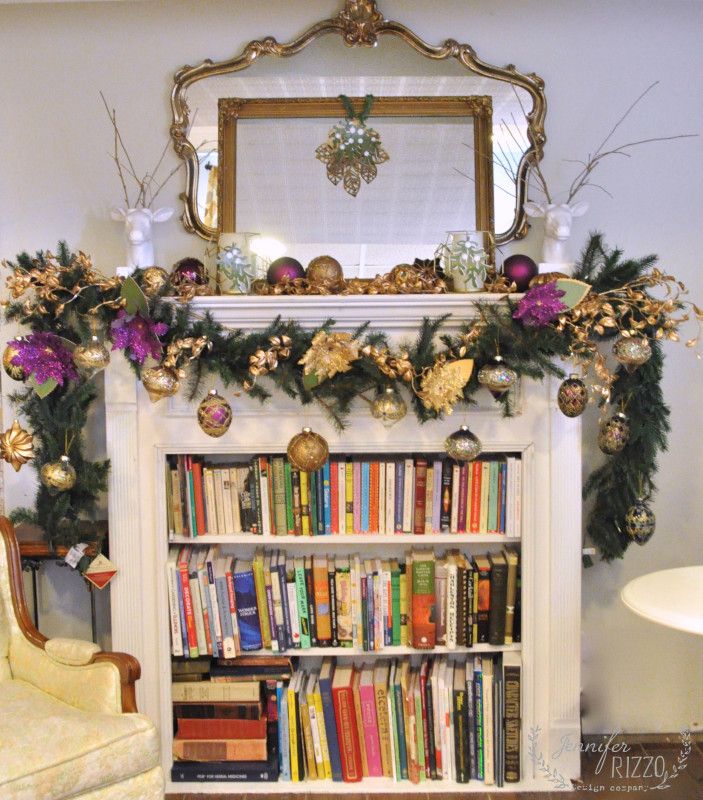 a fireplace decorated with christmas decorations and books