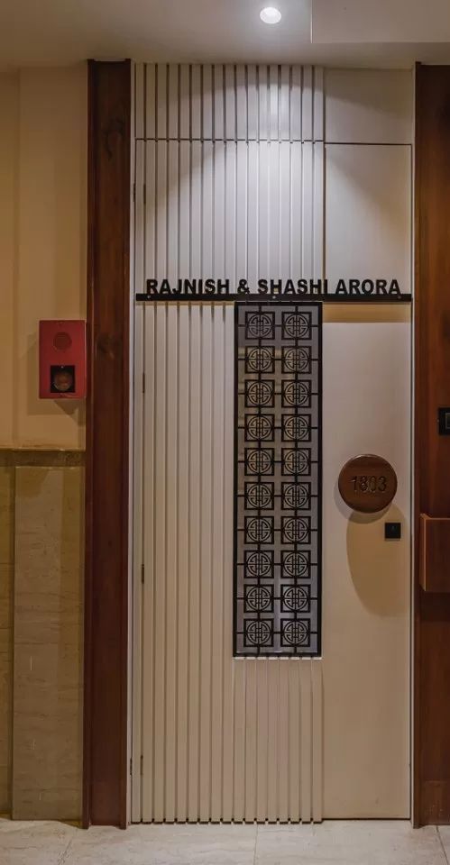 an entrance to a building with wooden doors and decorative paneling on the side wall