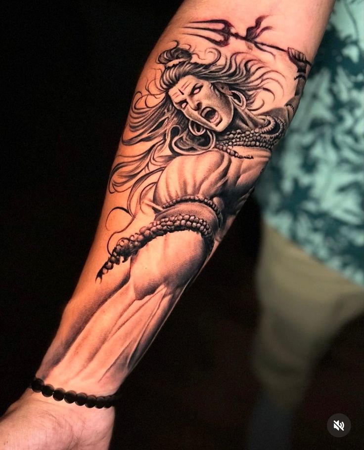 a woman's arm with a black and white tattoo design on her left arm