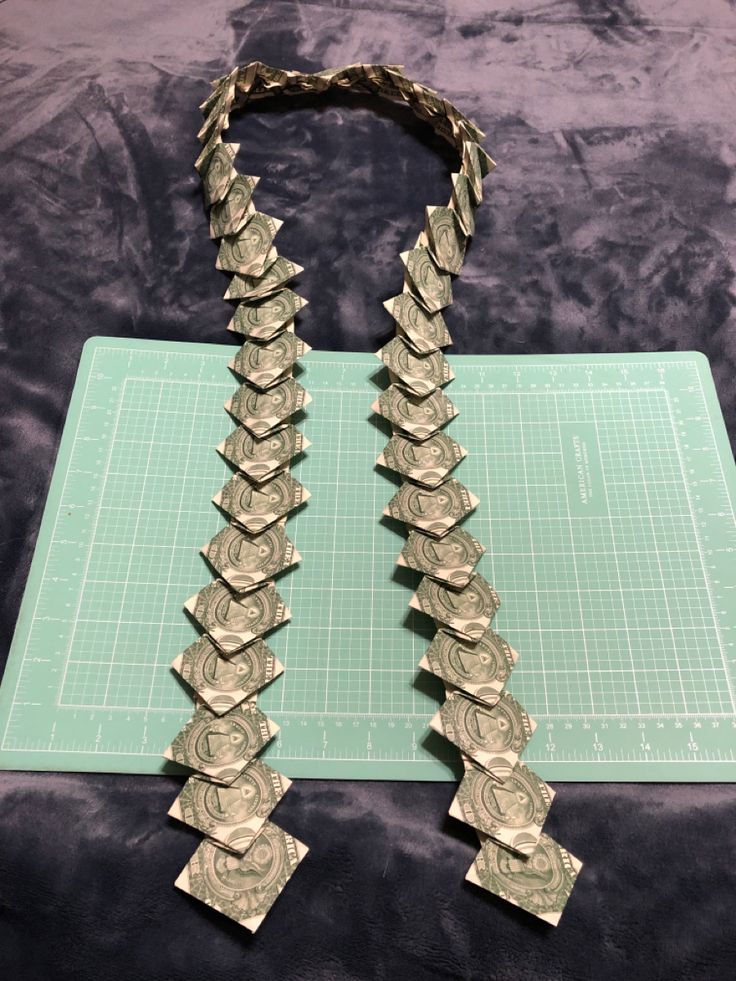 a couple of necklaces sitting on top of a cutting board