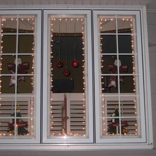 the window is decorated with christmas lights and decorations